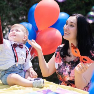 baby special day celebrate first birthday with balloons and bubble blowing and chasing soap bubbles