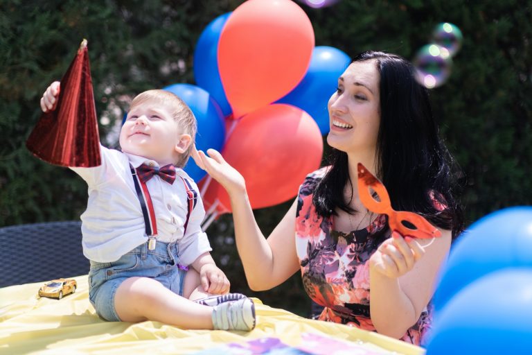 baby special day celebrate first birthday with balloons and bubble blowing and chasing soap bubbles